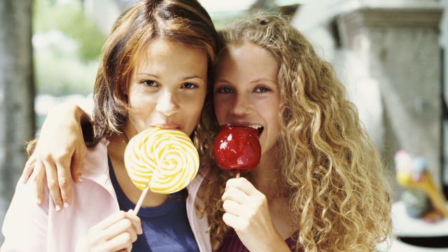Two girls eating candy