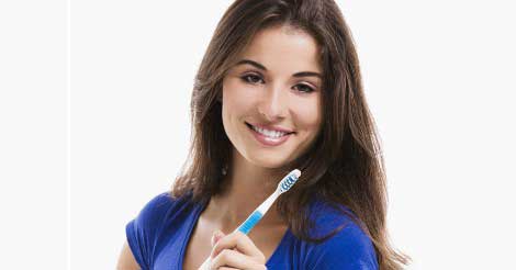Girl holding tooth brush and smiling