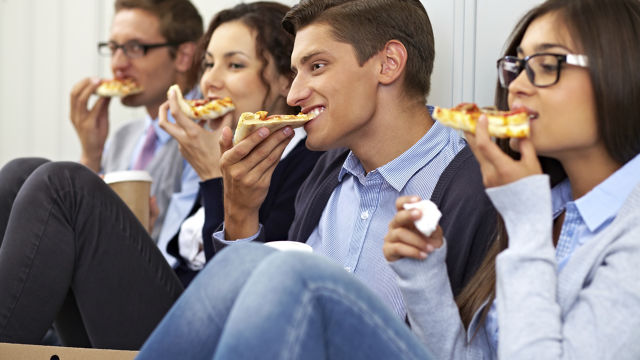 Group of people eating pizza