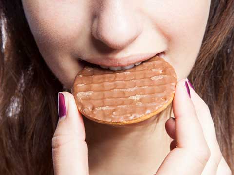 Girl eating a biscuit